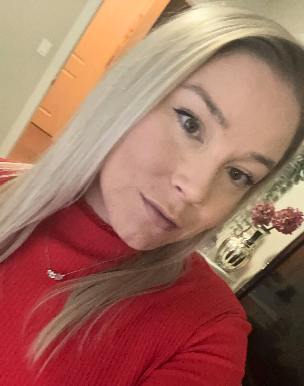 Stephanie James wearing a red shirt and straight blond hair.